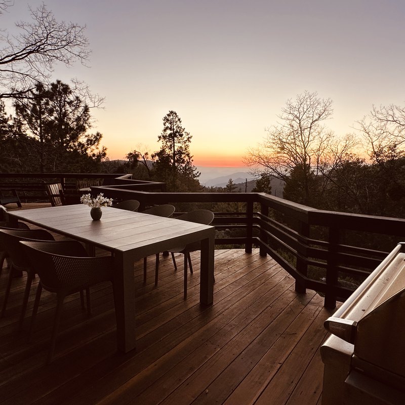 Deck dining table and BBQ at sunset over the valley