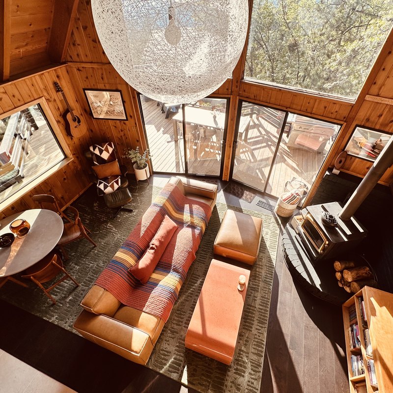 Living room seen from the loft, with wood stove and vaulted ceiling