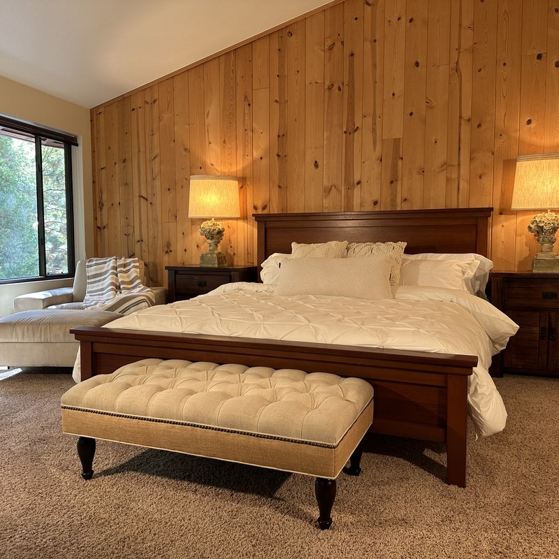 Bedroom with king bed and knotty pine walls